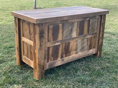 a wooden bench sitting on top of a lush green field