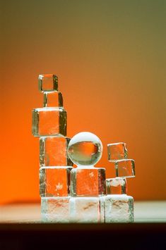 an orange and white sculpture made out of ice cubes on top of a table