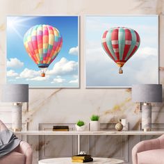 two hot air balloons floating in the sky above a living room with pink chairs and a coffee table