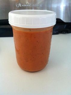 a jar of sauce sitting on top of a counter