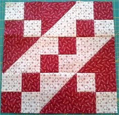 the block is made up of red and white squares with an arrow pointing to it