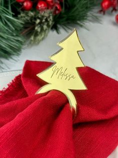 a red napkin with a gold christmas tree on it