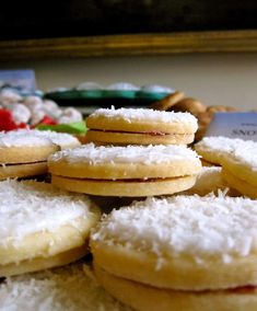 a pile of cookies sitting on top of a table covered in white powdered sugar