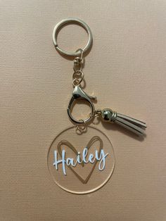 a keychain with a heart and the word hailey on it is shown