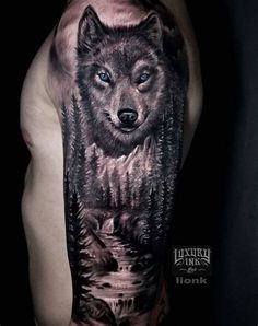 a man's half sleeve with a wolf and trees tattoo on his left arm