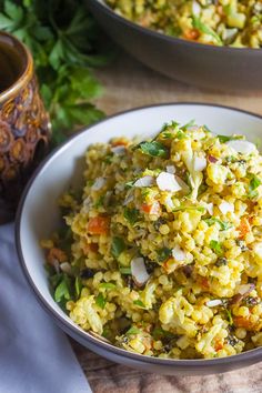 two bowls filled with rice and vegetables on top of a table