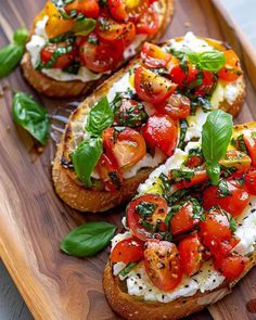 two slices of bread topped with tomatoes and basil