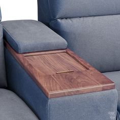 a close up of a couch with a wooden tray on it's back end