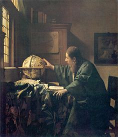 an image of a man looking at a globe