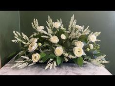 a bouquet of white flowers sitting on top of a table