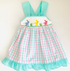 Bunny Smocked Dresses This adorable smocked dress is perfect for your little ones. They come in 5 different size (12M - 5T) and you can check the approximate measurement Washing Care Instructions Most items can be washed safely in cold water on delicate cycle and hung to dry. If the item that you are ordering has red or another bright color in it next to a white or other light color fabric please use a Shout color catcher for the first few washes to avoid bleeding. The reds are pre-washed but th Cute Gingham Smocked Dress With Ruffles, Multicolor Dresses With Smocked Bodice And Ruffled Straps, Cute Smocked Dress With Ruffled Straps, Playful Sleeveless Smocked Dress With Smocked Back, Sleeveless Smocked Dress With Smocked Cuffs, Cute Smocked Dress With Smocked Back For Playtime, Cute Multicolor Smocked Dress With Ruffles, Cute Multicolor Smocked Dress, Sleeveless Smocked Bodice Cute Dress