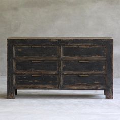 an old wooden dresser with four drawers on one side and two doors on the other