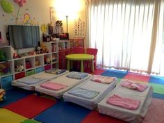 a child's playroom with several mattresses on the floor