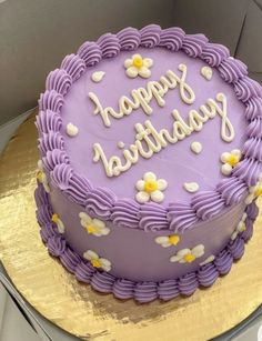 a purple cake with white flowers on it