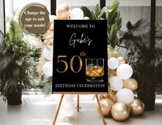 a 50th birthday celebration sign with gold and white balloons in front of a black welcome sign