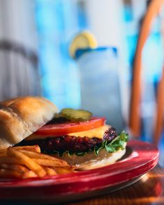 a hamburger and french fries on a red plate