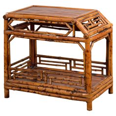 a bamboo table with two trays on each side and an open shelf below it