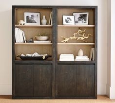 an open bookcase with books and pictures on it