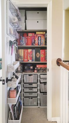 an organized pantry with bins, shelves and other items in the closet for storage