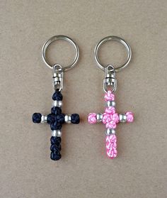 two cross shaped key chains with beads on each one and a beaded chain attached to the other