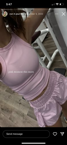 a woman in pink shirt and shorts taking a selfie