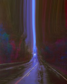 an empty road in the middle of a forest with blue and red lights on it