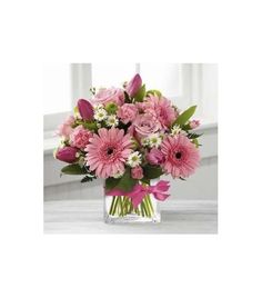 pink and white flowers in a square vase