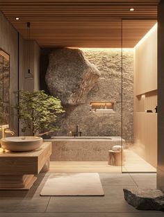 a bathroom with a large rock on the wall and a bathtub next to it