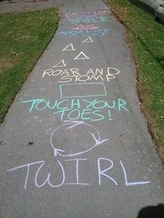 chalk writing on the sidewalk in front of a house