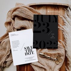 a black and white save the date card next to a pair of scissors