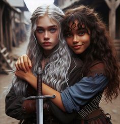 two young women are hugging each other while holding swords in their hands and looking at the camera