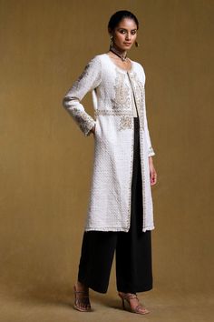 Off white full sleeve long jacket with floral, paisley embroidered motifs and side pockets.
Components: 1
Pattern: Embroidered
Type Of Work: Floral
Neckline: Round
Sleeve Type: Fringe
Fabric: Cotton Bookley
Color: Off White
Other Details: 
Note: Pant and inner worn by the model is not for sale
Occasion: Work,Party - Aza Fashions Elegant Long Outerwear With Intricate Embroidery, Elegant Long Embroidered Outerwear, Formal Long Sleeve Outerwear With Resham Embroidery, Long Embroidered Elegant Nehru Jacket, Embroidered Long Elegant Nehru Jacket, Elegant Long Embroidered Nehru Jacket, Elegant Embellished Nehru Jacket With Long Sleeves, Fall Wedding Outerwear With Intricate Embroidery, Fall Wedding Outerwear With Floral Embroidery