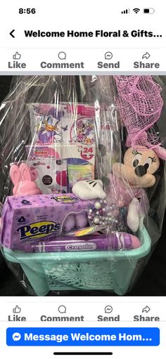 a basket filled with baby items on top of a table next to a sign that says welcome home floral & gifts like comment send