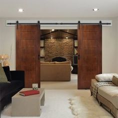 a living room filled with furniture and sliding doors