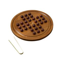 a wooden board with chocolates on it and two skewers next to it