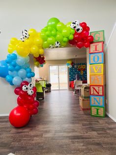 the balloon arch is decorated with many different colors and shapes for children's birthdays