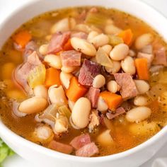 a white bowl filled with ham and bean soup