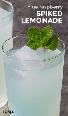 blue raspberry spiked lemonade in a glass with mint garnish on the rim