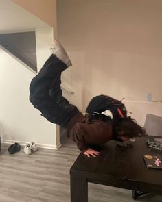 a person doing a handstand on a table