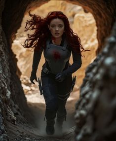 a woman with red hair is walking through a tunnel