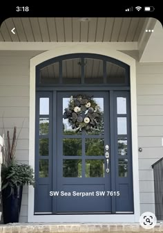 a blue front door with a wreath on it and the words sew sea serpent swf