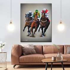 three jockeys on horses racing down the track in front of a brown couch and coffee table