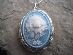 Beautiful cameo locket!!!  The cameo is beautifully detailed!!!  Wonderful gift for sisters, mothers, daughters, and friends!!!! The locket is victorian style with beautiful scroll on the front and back about 1 3/4" long.  It can hold two photos, keepsakes, or even your daily medication or vitamins!!! Pass down from generation to generation!!! The chain is 22"  1.2mm .925 plated snake chain with a lobster claw clasp!!! Perfect  for Brides or Bridal parties.  Makes a unique memorable gift for any Victorian Cameo Locket Necklace As A Gift, Cameo Medallion Locket Necklace For Keepsake, Cameo Medallion Locket Necklace Keepsake, Keepsake Medallion Locket Necklace With Cameo, Elegant Cameo Locket Necklace For Wedding, Cameo Medallion Locket Necklace For Weddings, Handmade Medallion Locket Necklace For Wedding, White Medallion Locket Necklace For Wedding, Cameo Locket