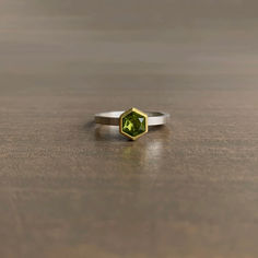 Citrusy peridot greens pack a punch alongside sleek silver and warm gold. 

22k yellow gold, sterling silver 
Peridot, 5mm x 6mm (3/16" x 1/4")