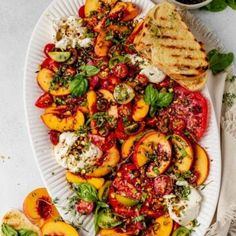 a white plate topped with grilled peaches and feta cheese