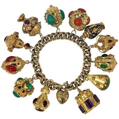 A beautiful vintage 18K Yellow Gold bracelet with both smooth and textured 11/32 inch wide links sporting 12 beautiful, Italian gold Estruscan Revival charms. One of the charms is a blue enamel perfumier, and the other 11 charms are set with various semi-precious stones including: amethyst, carnelian, coral, coral simulant, turquoise, sard, citrine, grossularite garnet, and chrysoprase. The oval, hat box shaped amethyst charm at one end of the bracelet, opens up to expose a secret compartment in Flexible Bracelet, Vintage Charm Bracelet, Gold Link Bracelet, Gold Charm Bracelet, Small Rings, Gold Collection, Pandora Jewelry, Gold Charm, Italian Charm Bracelet