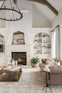 a living room filled with furniture and a fire place in the middle of a room