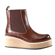 A real retro-inspired favorite, She Nah by Diba True has arrived on the scene. A sleek leather upper with slight antiquing on the toe bed meets sleek gore panels that rest on a 2.5 inch stacked platform wedge with a padded insole for maximum comfort. Size: 6.  Color: Brown.  Gender: female.  Age Group: adult. Brown Faux Leather Wedge Boots With Round Toe, Brown Wedge Boots With Reinforced Heel And Round Toe, Brown Wedge Boots With Leather Sole And Round Toe, Leather Wedge Boots With Round Toe, Casual Brown Platform Wedge Boots, Brown Ankle Wedge Boots With Reinforced Heel, Fall Leather Platform Wedge Boots, Brown Leather Wedge Heel Boots, Leather Wedge Boots With Platform And Round Toe