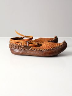 "This is a pair of vintage Turkish leather shoes. The hand-crafted woven leather shoes feature a classic pointed upturned, leather soles, and an ankle strap with buckle closure. Two tone coloring adds to their style. CONDITION In good condition with wear consistent with wear and use. APPROXIMATE FIT: Women's US 8 MEASUREMENTS Insole Length: 9.5\" .. 24.1 cm Outsole Length: 10.25\" .. 26 cm Width: 3.75\" .. 9.5 cm Height: 2.25\" .. 5.7 cm Circumference Ankle Strap: 12.5\" .. 31.8 cm 1120207" Vintage Brown Flat Leather Shoes, Vintage Leather Sandals With Flat Heel, Leather Moccasins With Woven Sole, Brown Vintage Sandals With Leather Sole, Vintage Brown Sandals With Leather Sole, Vintage Flat Heel Sandals With Rubber Sole, Vintage Sandals With Flat Heel And Rubber Sole, Vintage Leather Flat Shoes With Rubber Sole, Vintage Brown Moccasins With Rubber Sole