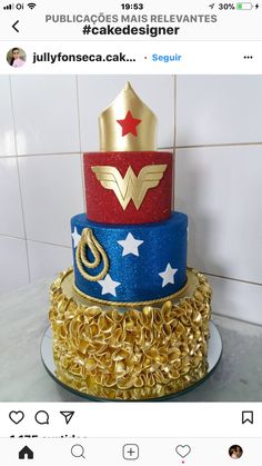 there is a three layer cake with gold decorations on the top and red, white, and blue frosting